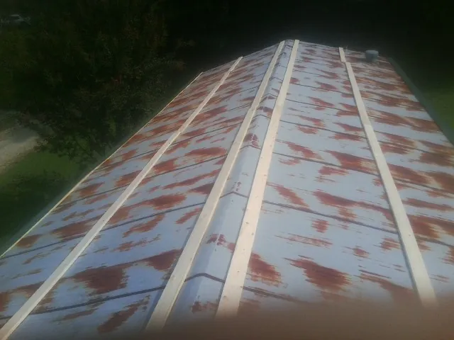 Rusted metal roof panels with new wood purlins before replacement — Storm Damage Roof Repair in Machipongo by Roofing Brothers
